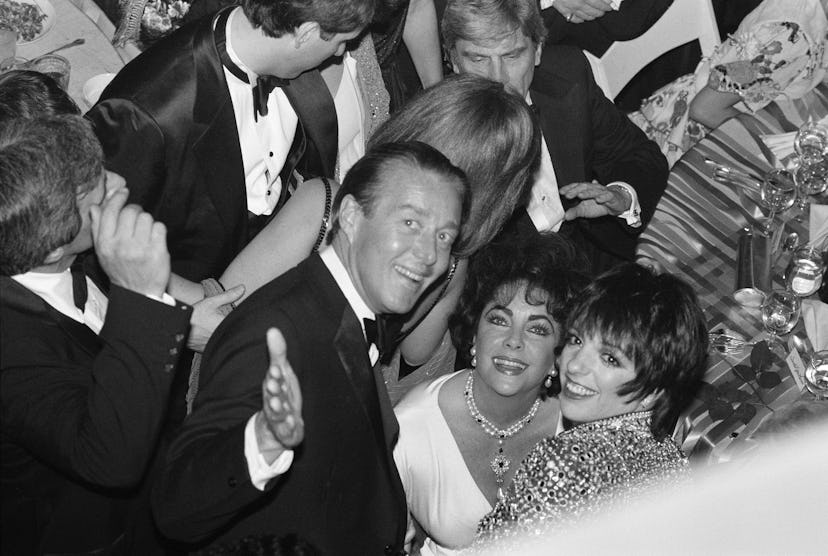 Fashion designer, Halston, actress Elizabeth Taylor and singer and actress Liza Minnelli smile at th...