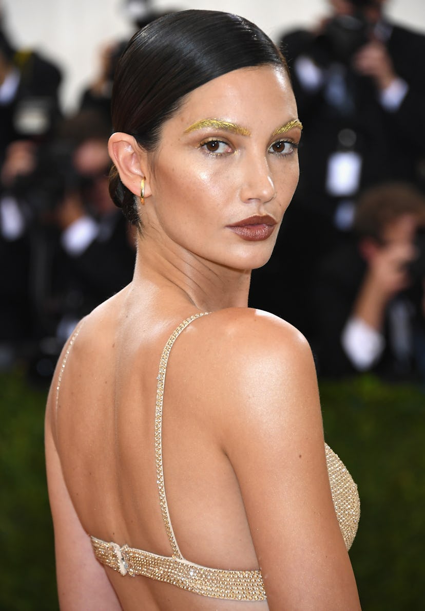 Lily Aldridge's daring look at the 2016 Met Gala perfectly complemented her gilded gown and sleek up...