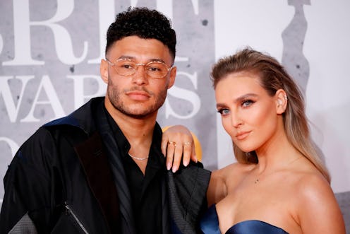 British footballer Alex Oxlade-Chamberlain and girlfriend Perrie Edwards (R) pose on the red carpet ...