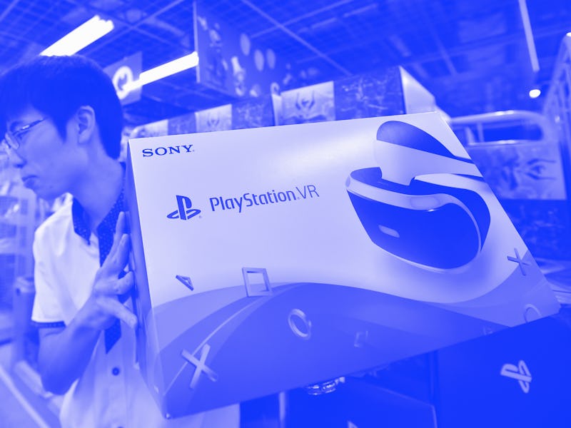 An employee of an electronics retail shop sells the new Sony PlayStation virtual reality (PSVR) head...