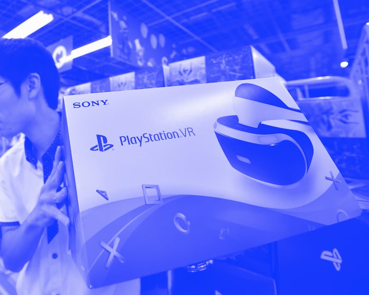 An employee of an electronics retail shop sells the new Sony PlayStation virtual reality (PSVR) head...