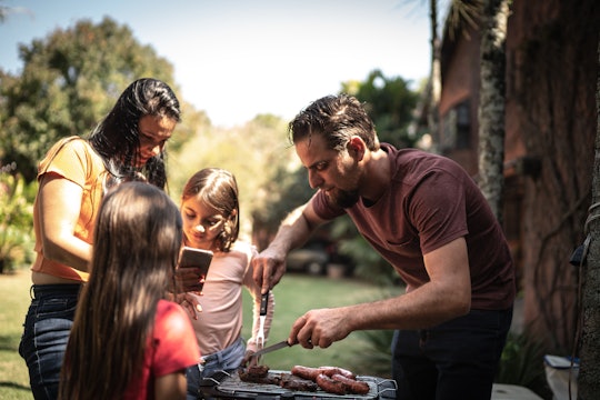 Family doing a barbecue together in the backyard