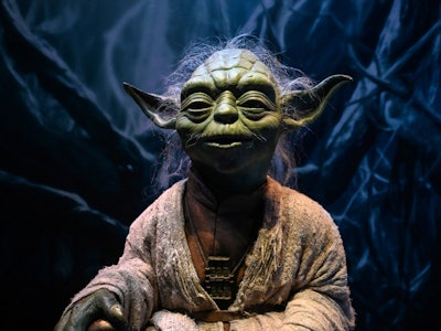 A life-size figurine of Yoda from the Star Wars series is displayed at the Star Wars Identities exhi...