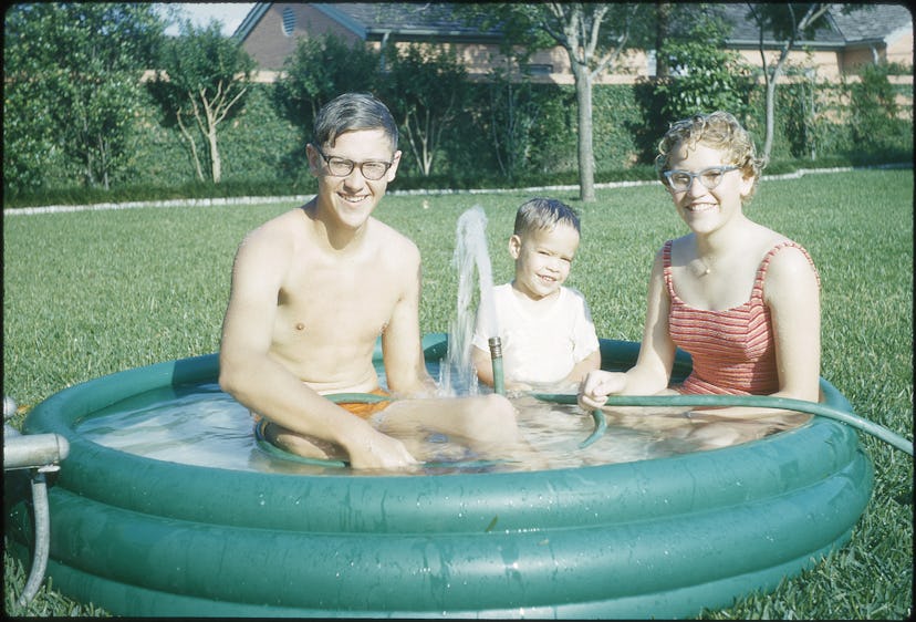 A family enjoying an inflatable pool.