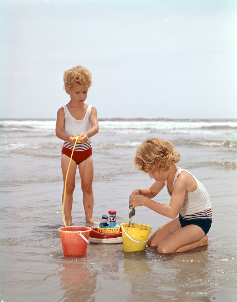 Kids playing on the beach in the 1960s.