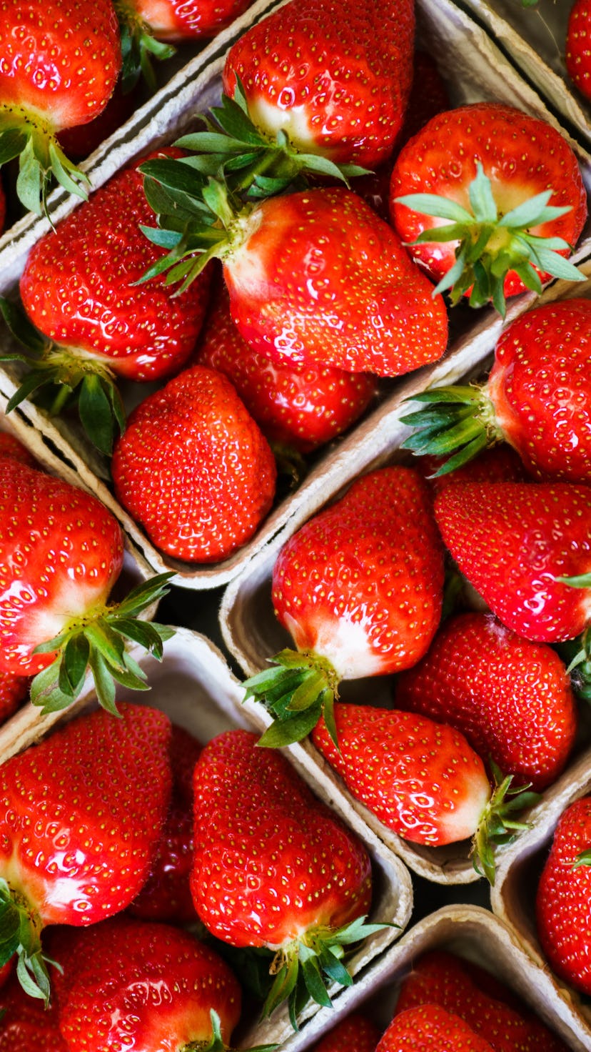Harvested strawberries lie in the baskets.