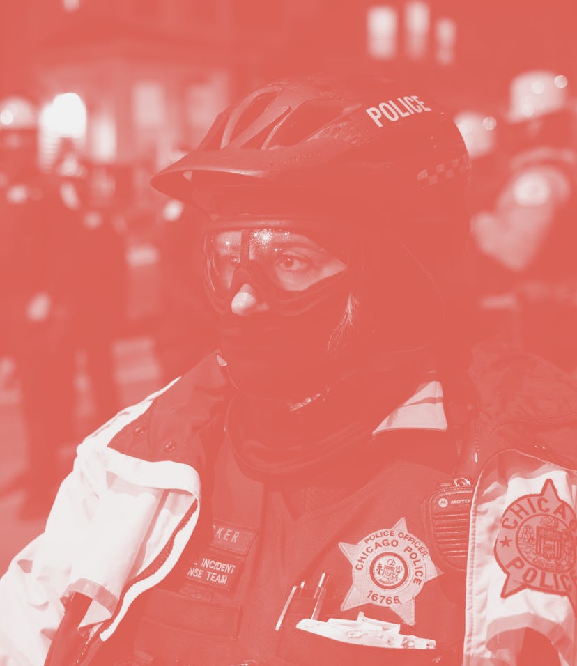 CHICAGO, April 16, 2021 -- A police officer stands before protesters during a protest in Chicago, th...