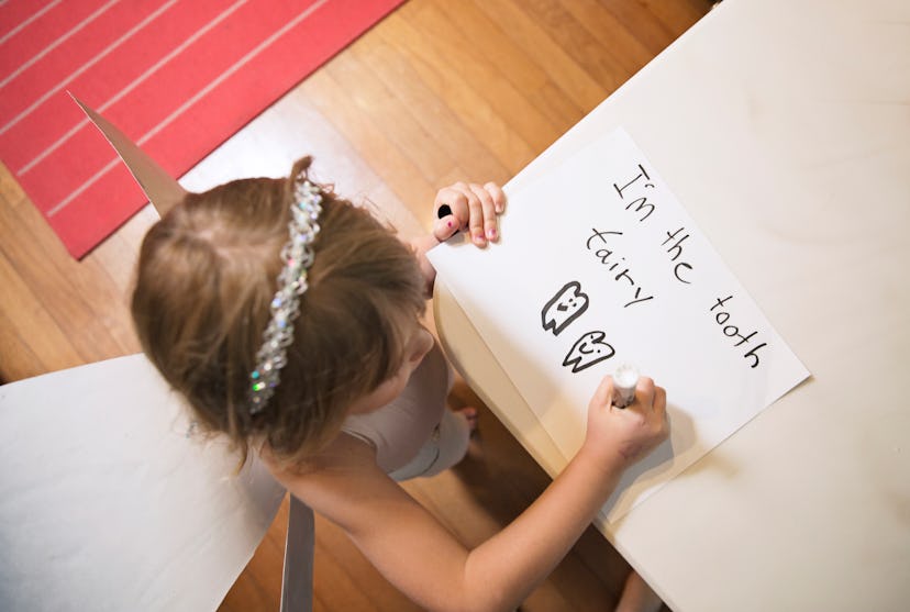 little girl writing letter to tooth fairy, how to talk to kids about the tooth fairy