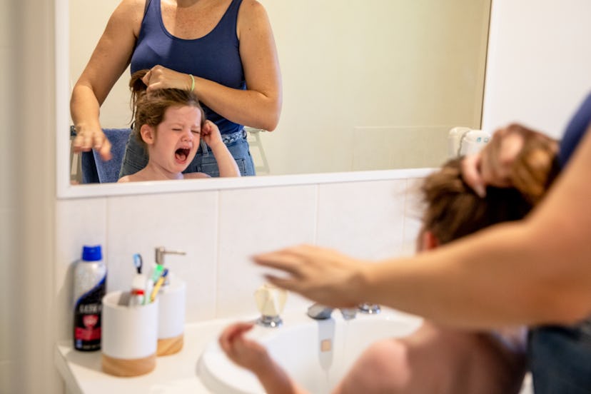 Single Mother with her daughter and son at home playing, working and involved in domestic duties.