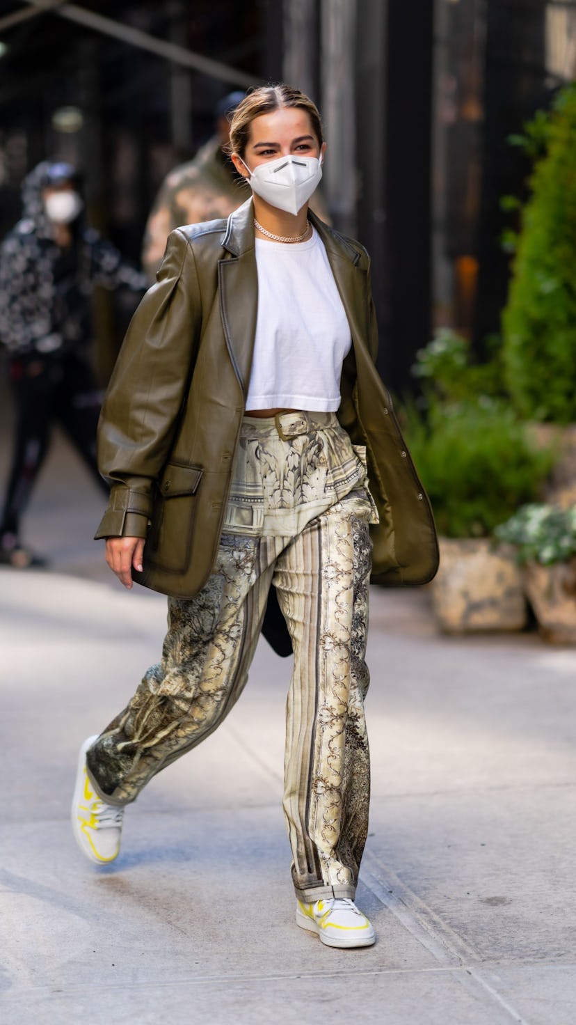 Addison Rae wears Baroque-print pants and a leather blazer on the street in one of her outfits to da...