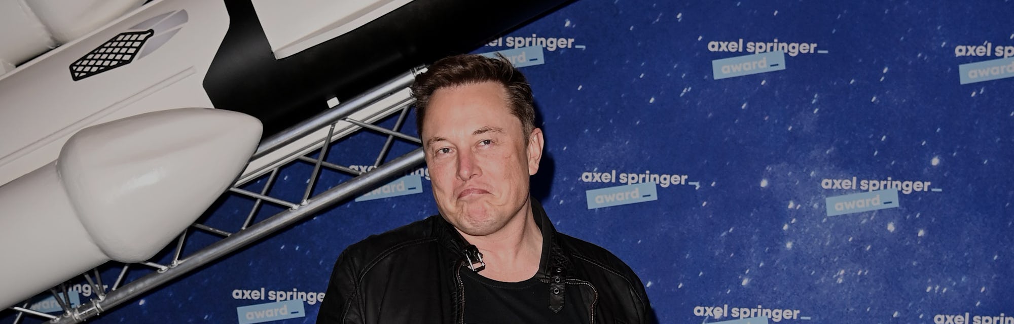 SpaceX owner and Tesla CEO Elon Musk (R) gestures as he arrives on the red carpet for the Axel Sprin...