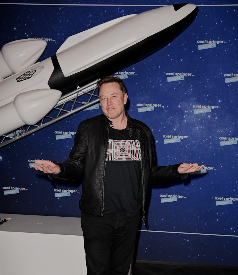 SpaceX owner and Tesla CEO Elon Musk (R) gestures as he arrives on the red carpet for the Axel Sprin...