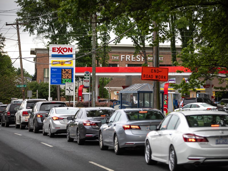 Motorists line up at an Exxon station selling gas at $3.29 per gallon soon after it's fuel supply wa...