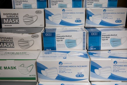 Boxes of PPE, Personal protective equipment, specifically face masks stacked up waiting to be used i...