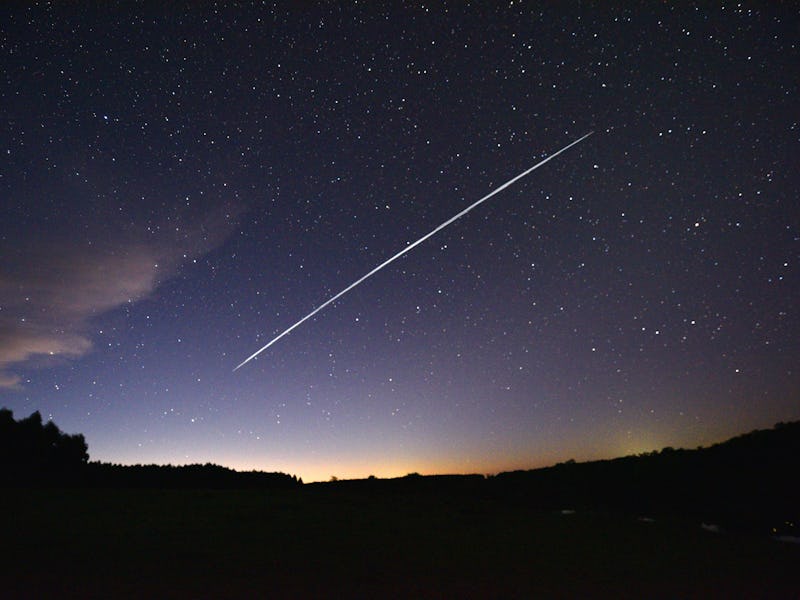 TOPSHOT - This long-exposure image shows a trail of a group of SpaceX's Starlink satellites passing ...