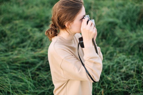 woman taking a picture with her camera