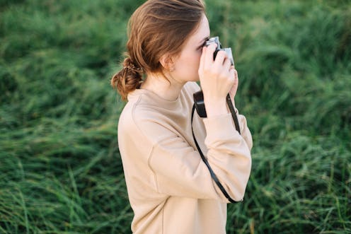 woman taking a picture with her camera