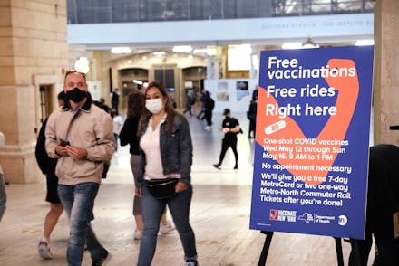 NEW YORK, NEW YORK - MAY 12: People walk through Grand Central Terminal where a pop-up site for COVI...