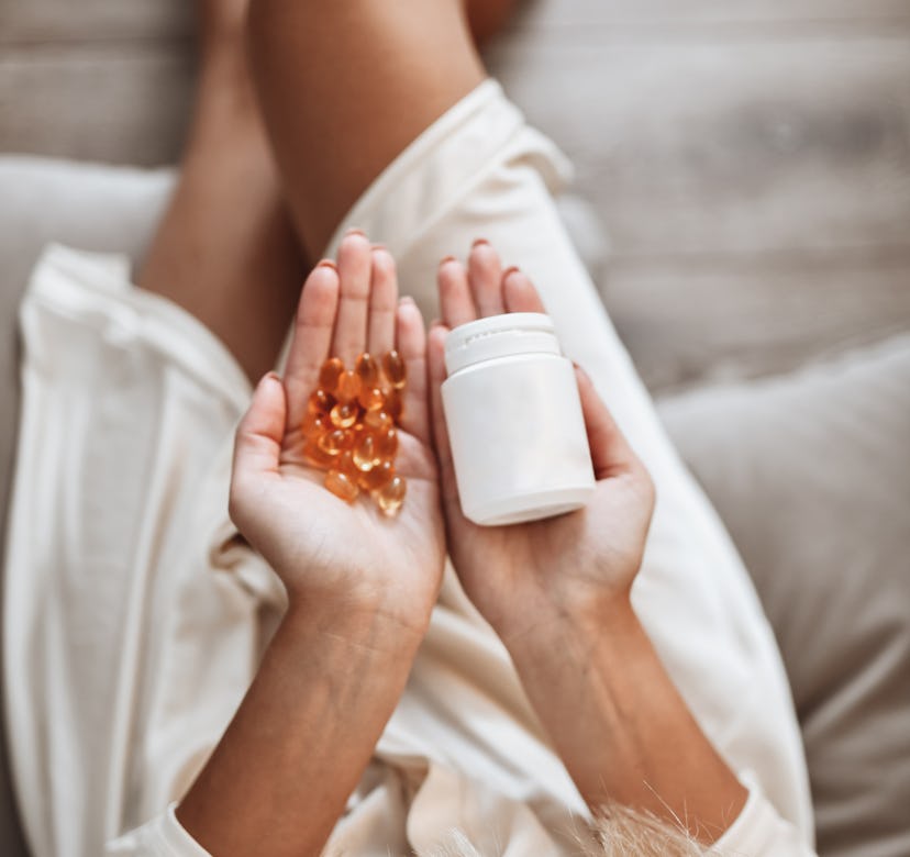 Vitamin Bunch In Hand Of Female Wearing Bathrobe
