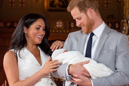 Britain's Prince Harry, Duke of Sussex (R), and his wife Meghan, Duchess of Sussex, pose for a photo...