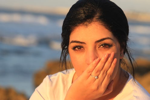 woman covering her mouth