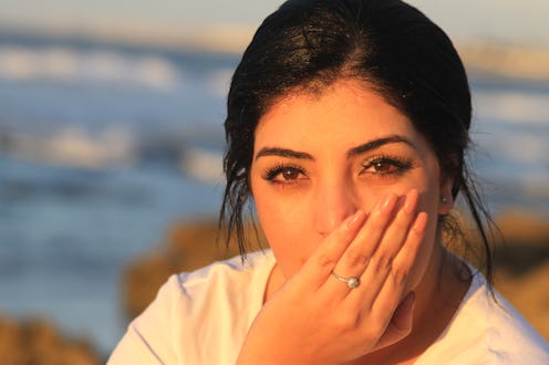 woman covering her mouth