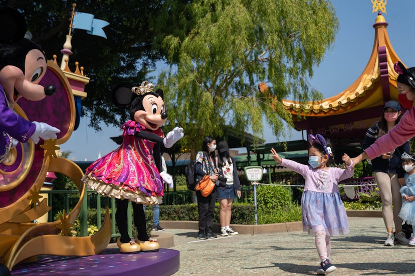 HONG KONG, CHINA - 2021/02/19: A child interacts with the actors dressed as the Disney cartoon chara...