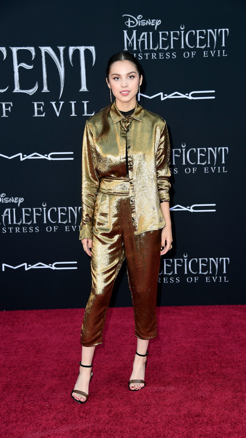 Olivia Rodrigo wears a full gold metallic shirt and pants set while attending the World Premiere Of ...