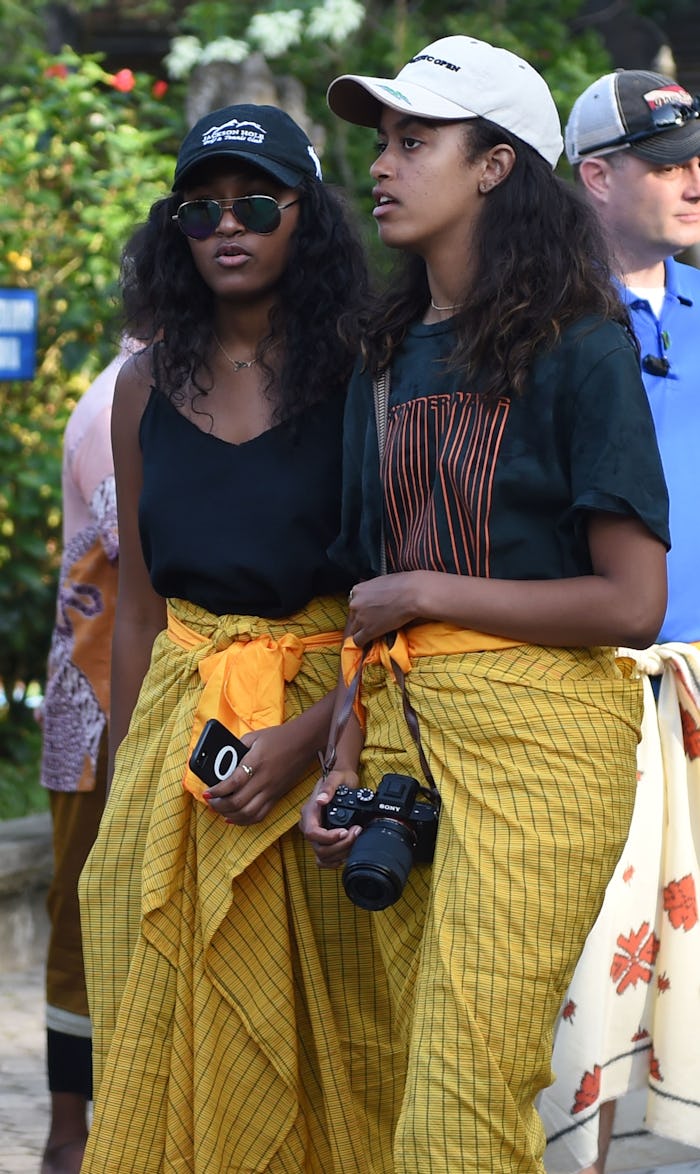 Sasha (L) and Malia (R), daughters of former US president Barack Obama, visit Tirtha Empul temple at...