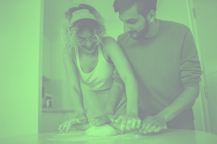 A happy couple kneads some dough to make Frog Bread from TikTok at home.