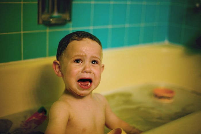 Toys in a bathtub help a toddler be less afraid of bath time.