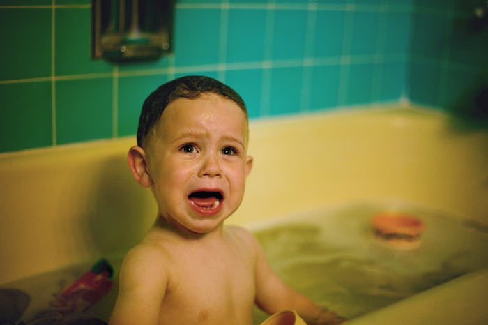 Toys in a bathtub help a toddler be less afraid of bath time. 
