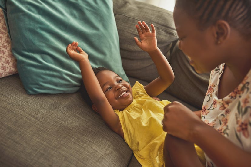 A toddler plays with her mom on a couch. Anisa means "pleasant companion" and is a sweet Gemini girl...