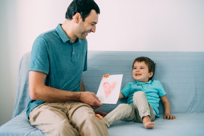 Cute little boy gives a greeting card to his dad, what to write in a father's day card