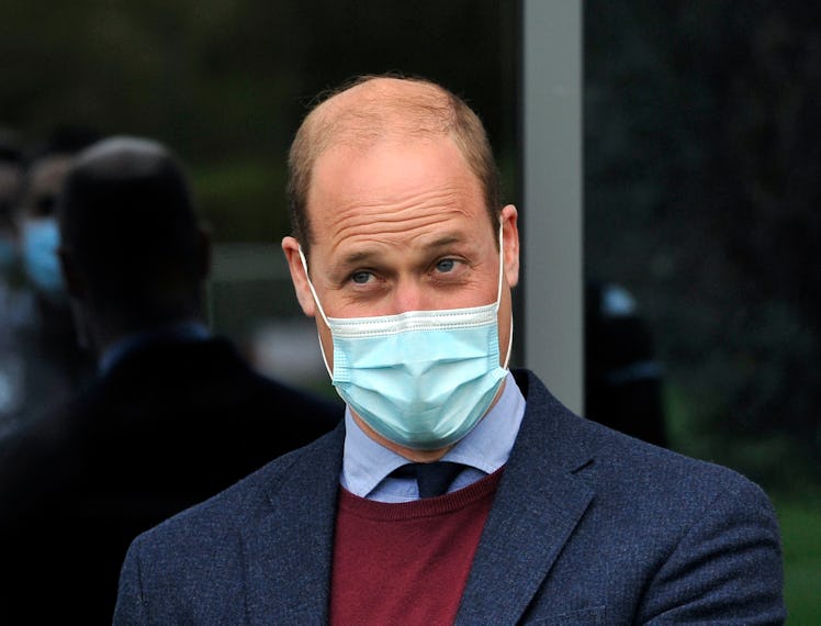 Britain's Prince William, Duke of Cambridge gestures as he meets Aston Villa football players during...