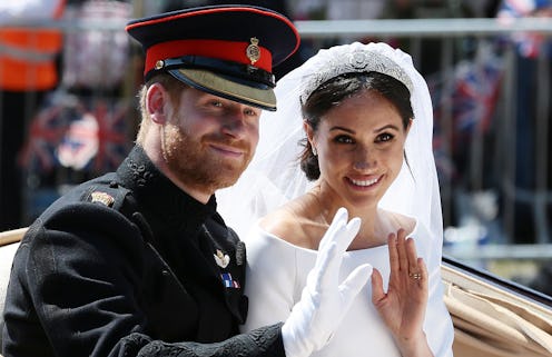 TOPSHOT - Britain's Prince Harry, Duke of Sussex and his wife Meghan, Duchess of Sussex wave from th...