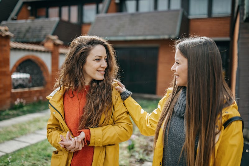 Two friends walking and drinking coffee after one gives the other a backhanded compliment. These backhanded compliment examples can help you sort out if your friend is being thoughtless or just plain rude.