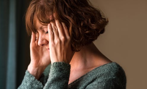A woman practices EFT tapping for anxiety.