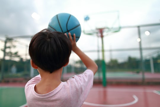 Cute little boy playing basketball