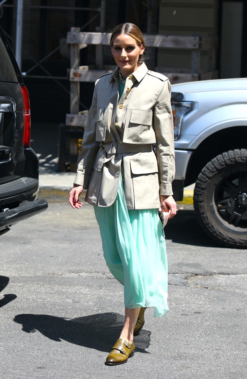 Olivia Palermo styled a chic army jacket with a turquoise midi skirt and olive brogues.