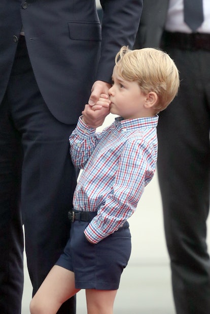 Prince George kisses his dad's hand.