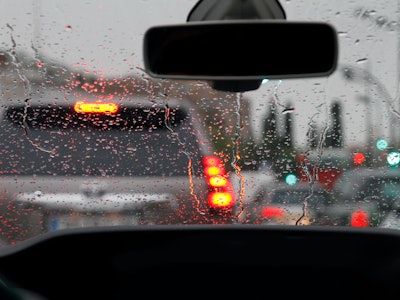 View from car with rain drops of traffic jam in the street