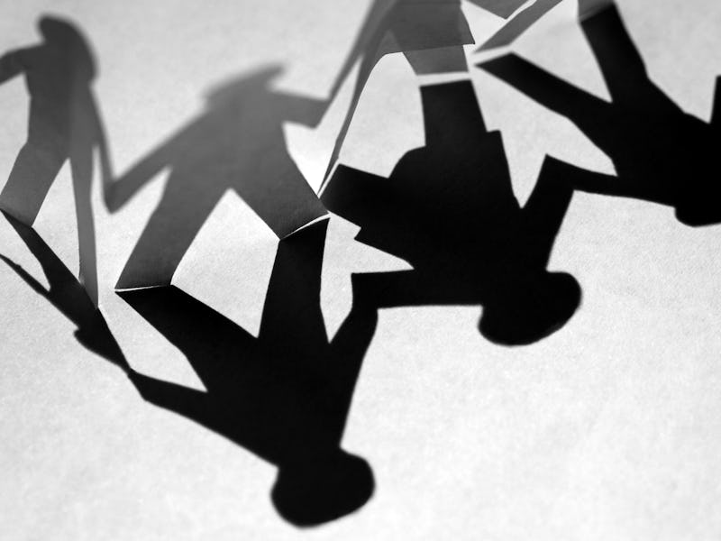 Three black stickmen holding hands together