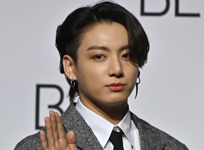 South Korean K-pop boy band BTS member Jung Kook poses for a photo session during a press conference...