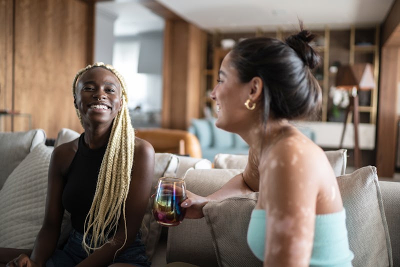 Two female friends laughing, wondering "Are we more than just friends"?