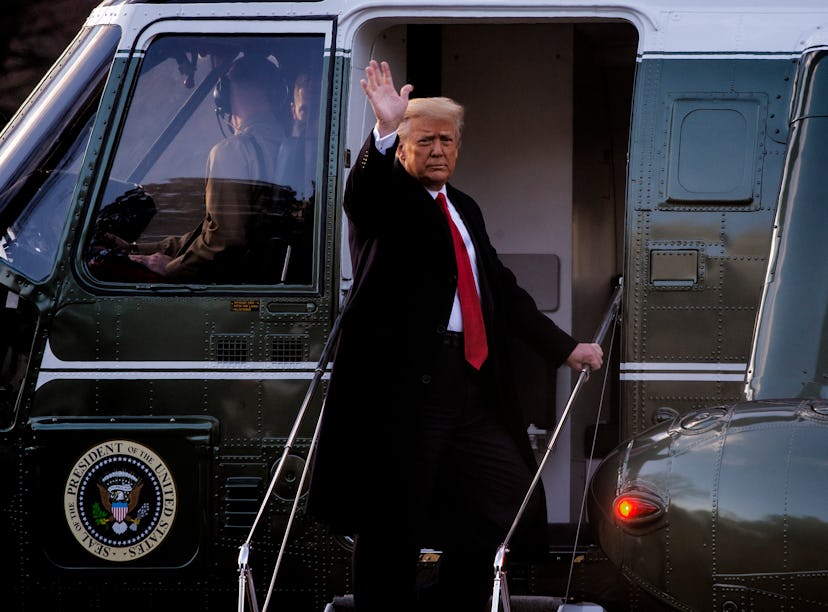 President Donald Trump gives a final wave as he boards Marine One as he and First Lady Melania Trump...