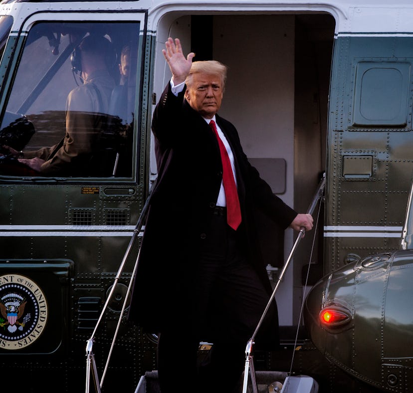 President Donald Trump gives a final wave as he boards Marine One as he and First Lady Melania Trump...