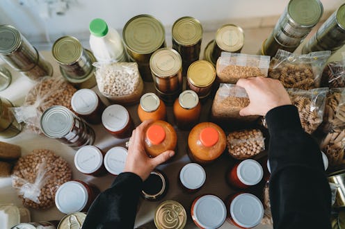A woman arranges bottles and jars of foods you can eat past the expiration date.