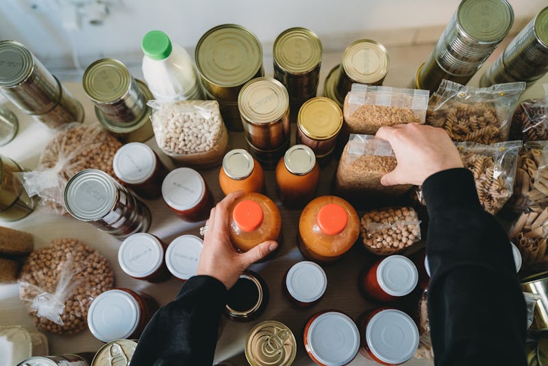 A woman arranges bottles and jars of foods you can eat past the expiration date.