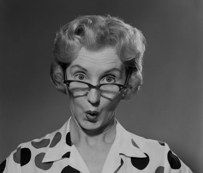 1950s 1960s PORTRAIT WOMAN POLKA DOT DRESS LOOKING AT CAMERA OVER EYEGLASSES (Photo by Debrocke/Cla...